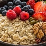 A healthy breakfast bowl of oatmeal topped with fresh berries, nuts, and seeds, illustrating high fiber content for heart health.